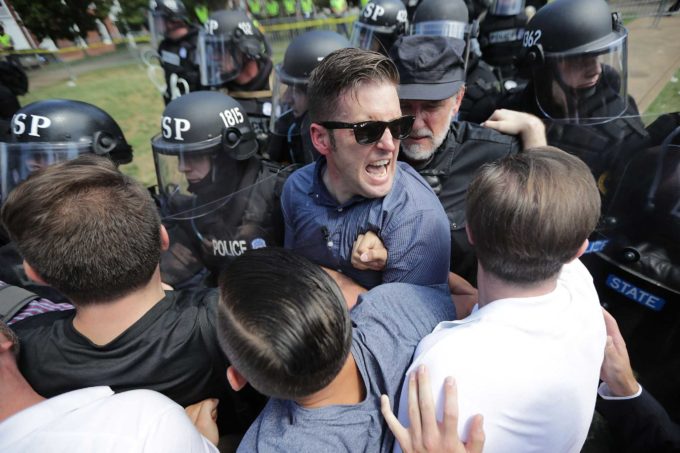 CHARLOTTESVILLE, VA - AUGUST 12:  White nationalist Richard Spencer (C) and his supporters clash with Virginia State Police in Lee Park after the "United the Right" rally was declared an unlawful gathering August 12, 2017 in Charlottesville, Virginia. Hundreds of white nationalists, neo-Nazis and members of the "alt-right" clashed with anti-facist protesters and police as they attempted to hold a rally in Lee Park, where a statue of Confederate General Robert E. Lee is slated to be removed. (Photo by Chip Somodevilla/Getty Images)